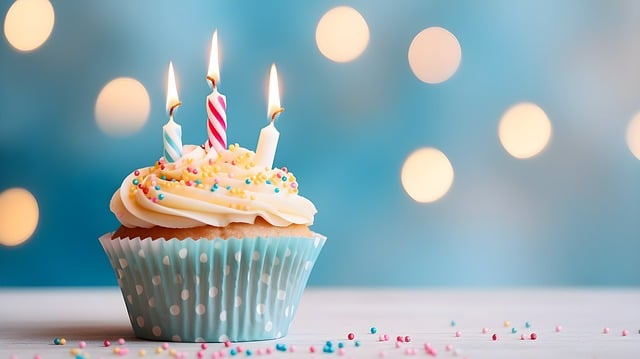 birthday cupcake with lit candles on it